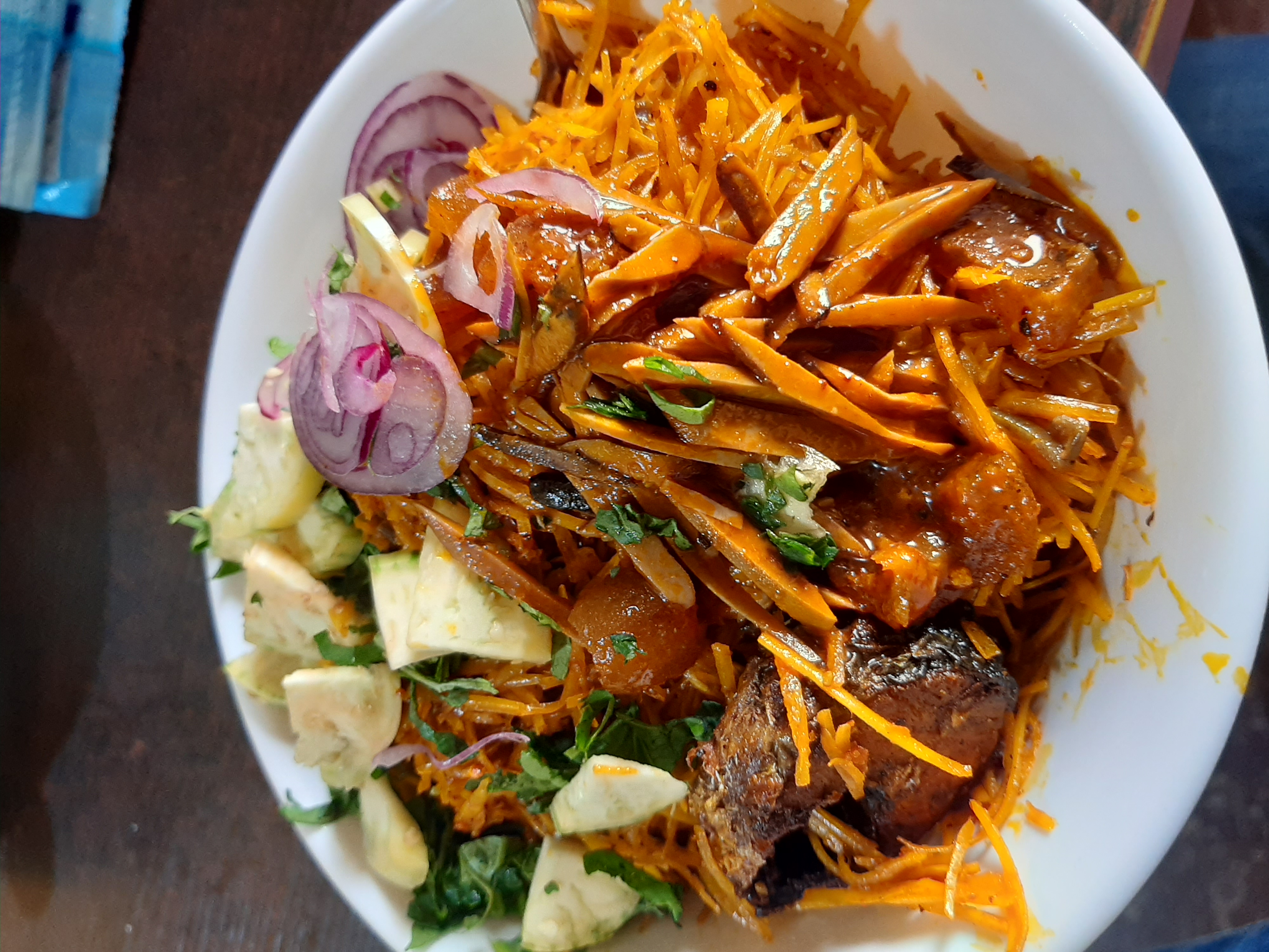 Abacha cassava salad with ugba, garden egg, onion, greens and fish