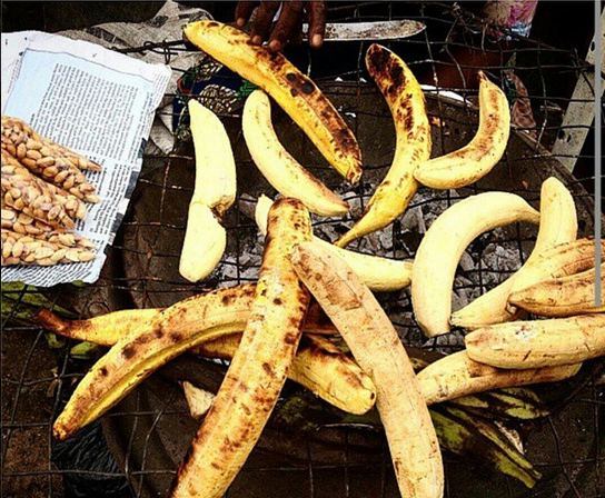 Boli plantains roasting beside groundnuts