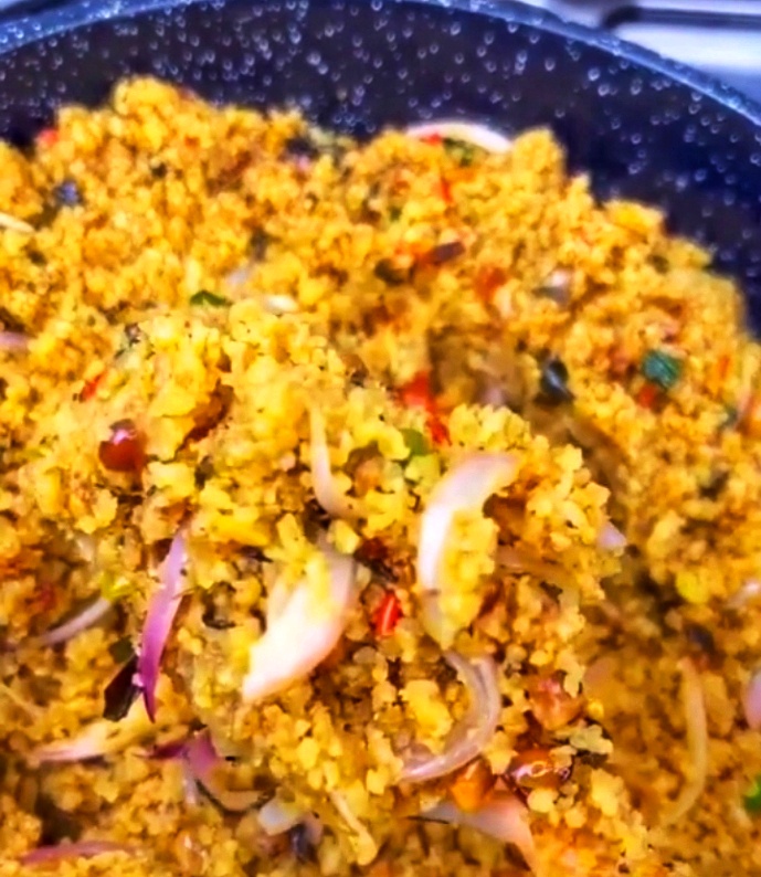 Dambu shinkafa with groundnuts, greens and red onion