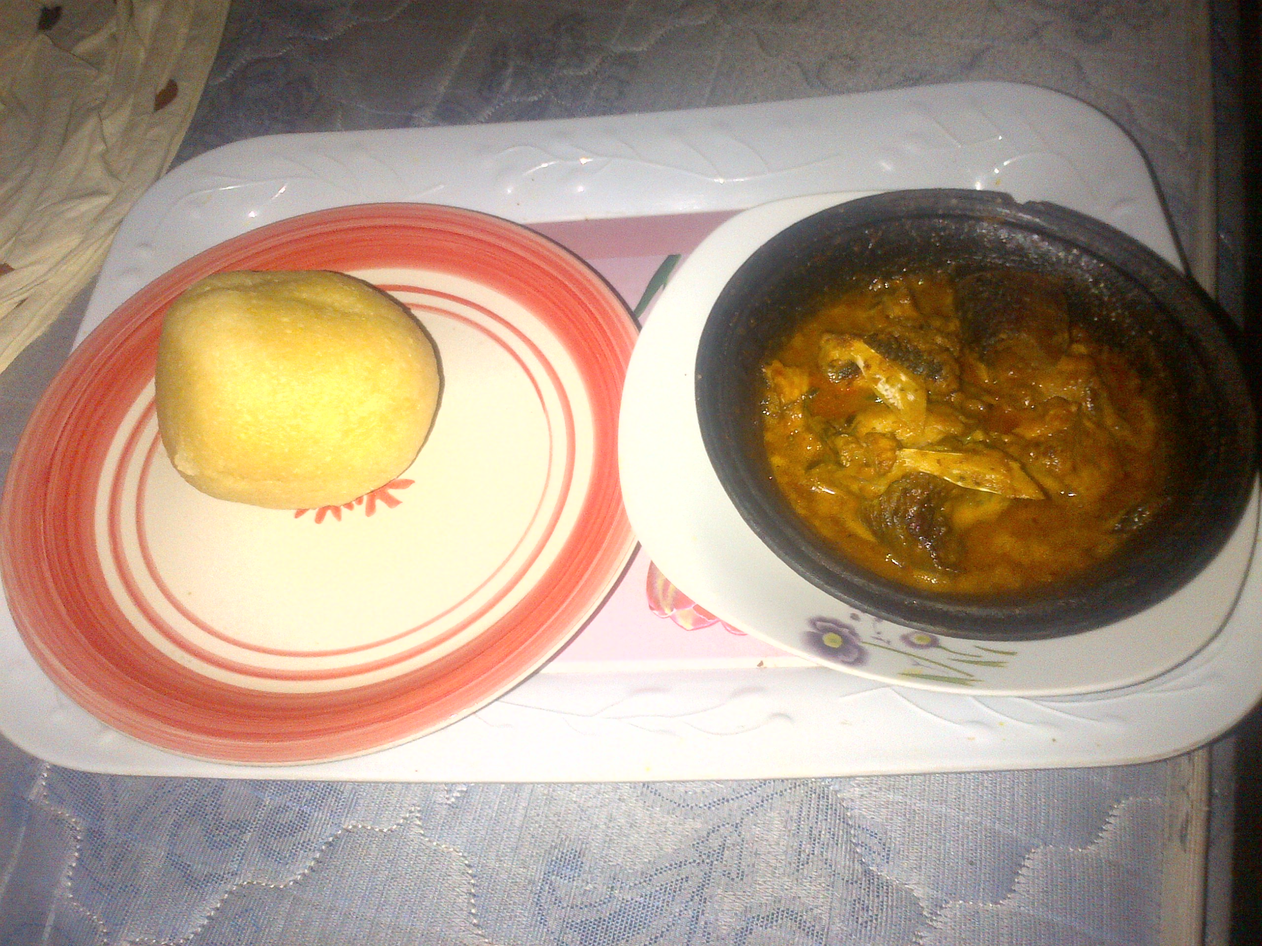 Fish banga soup in a clay pot with eba alongside