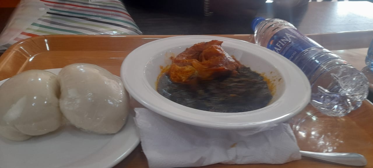 Ewedu with a stew topping and pale swallow portions