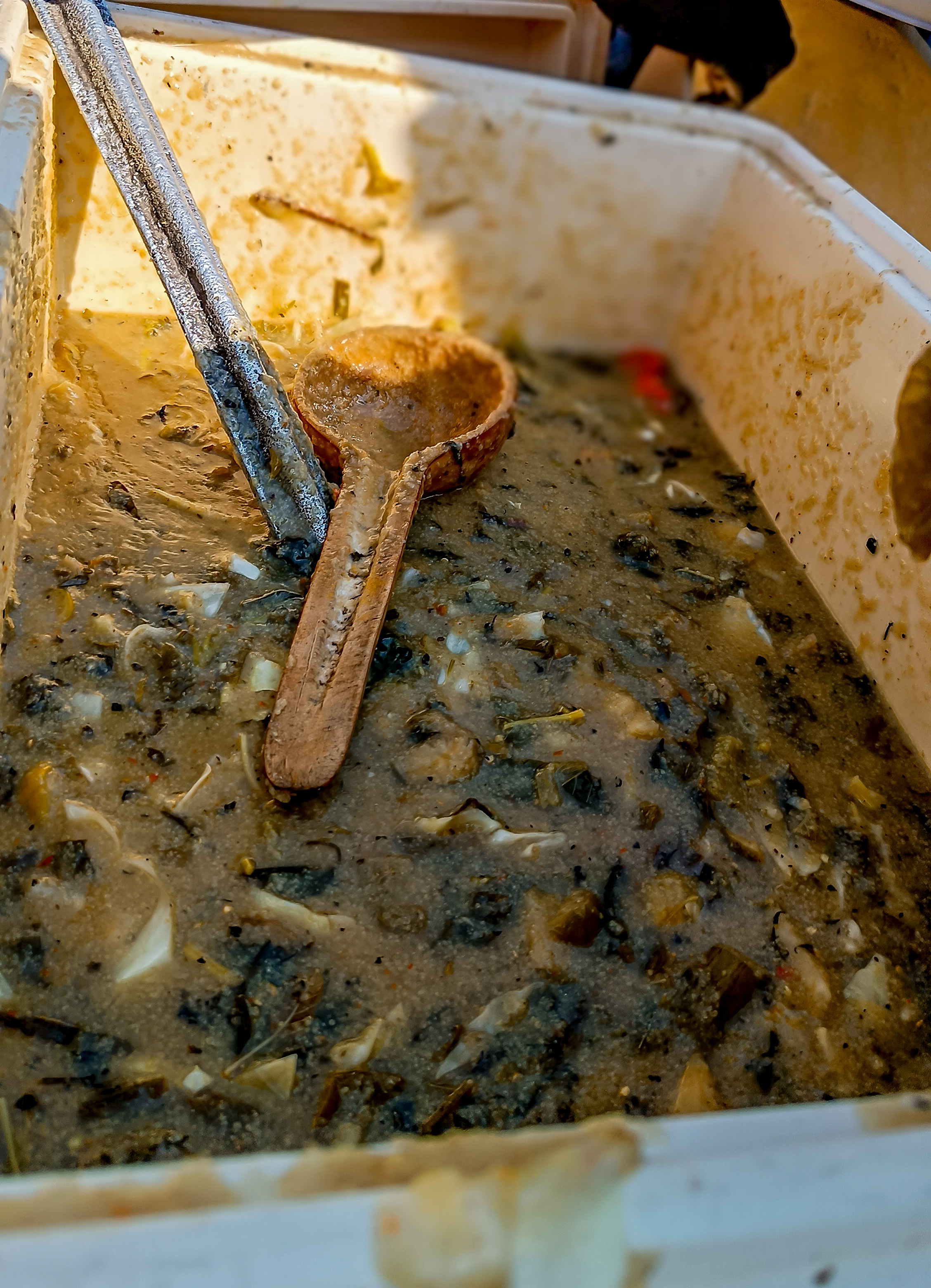 Gwate acha porridge with greens in a serving container