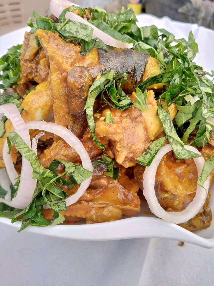 Isi ewu meat and skin pieces with onion and leafy garnish