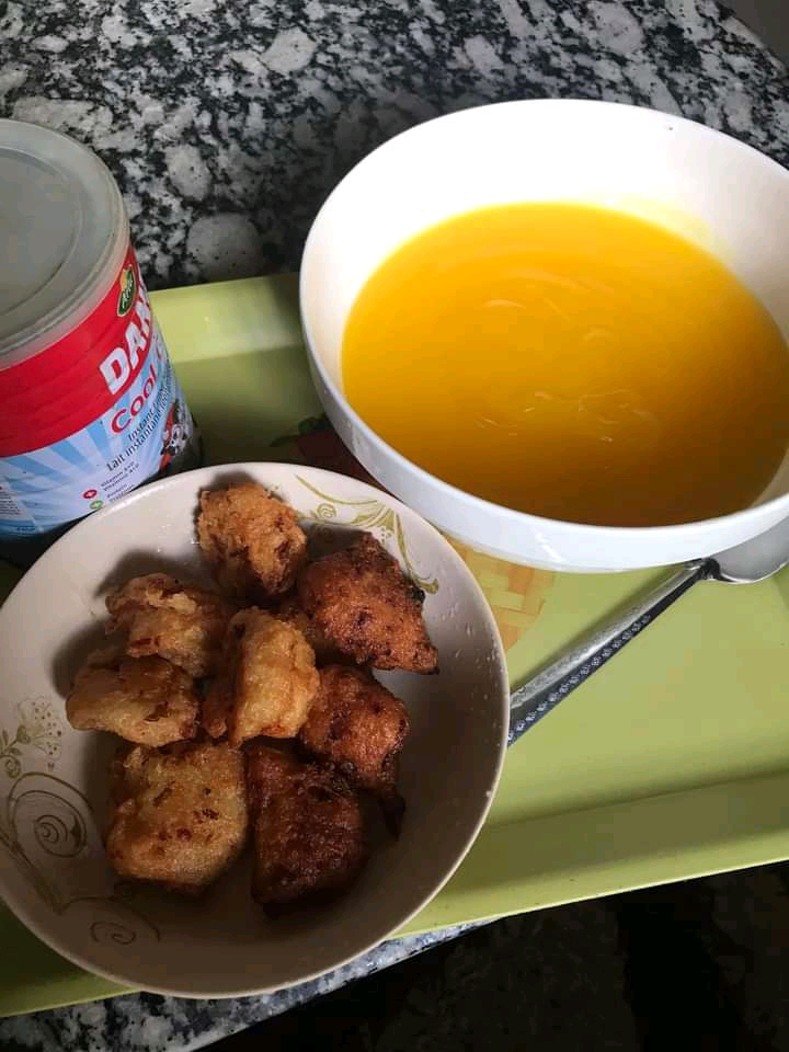 Ojojo yam fritters beside yellow pap