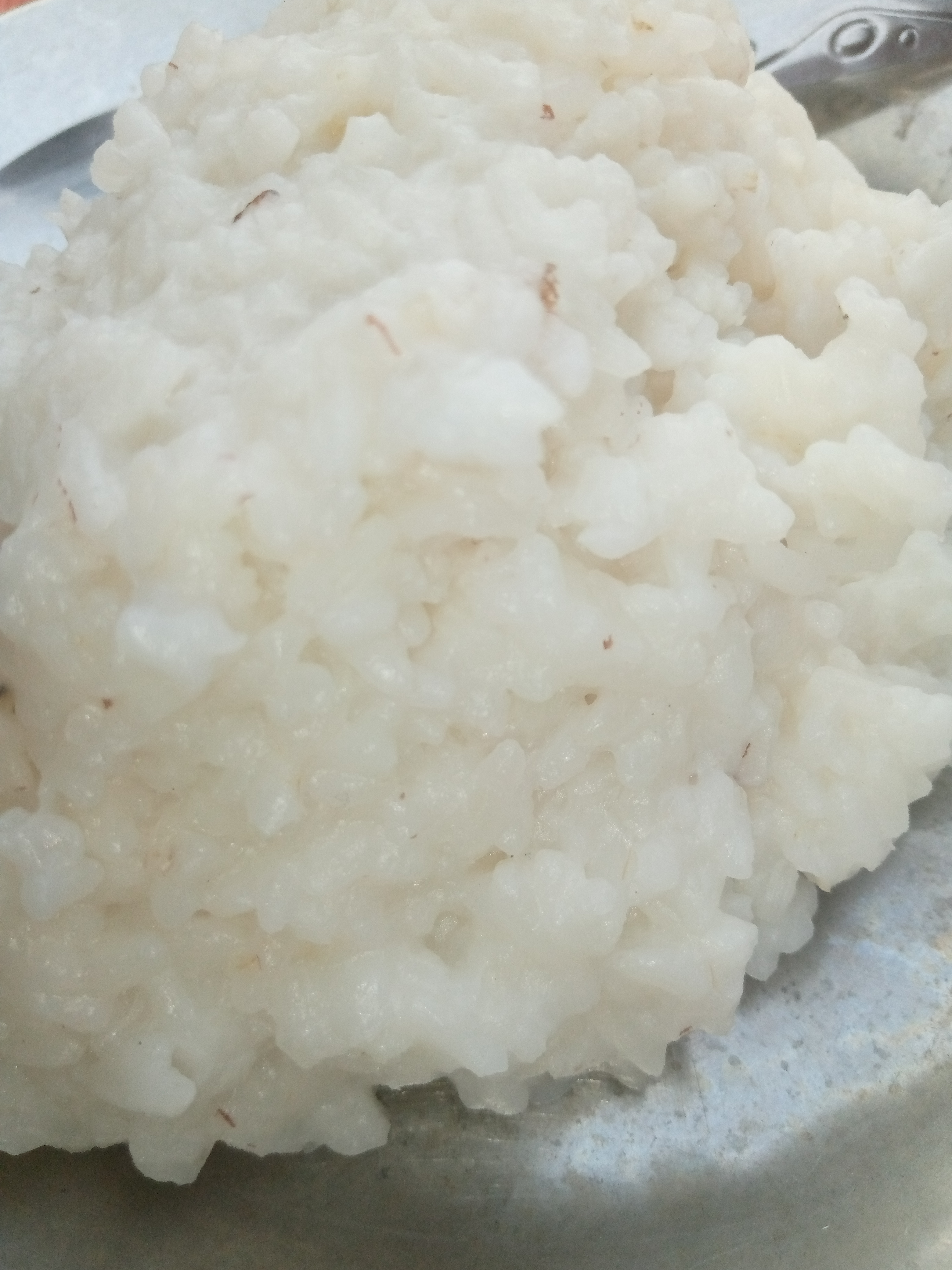 Tuwo shinkafa rice mash on a metal plate